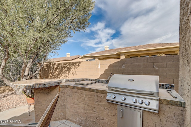 3660 S Golden Eye Ln, Gold Canyon, AZ 85118 - view of patio / terrace with grilling area, an outdoor kitchen, and fence