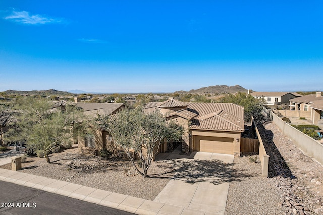 3660 S Golden Eye Ln, Gold Canyon, AZ 85118 - view of front facade with fence, a tiled roof, a garage, concrete driveway, and a mountain view