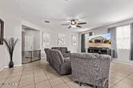 2614 S 120th Ave, Avondale, AZ 85323 - living area with tile patterned floors, ceiling fan, and baseboards
