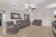 2614 S 120th Ave, Avondale, AZ 85323 - living room featuring ceiling fan, tile patterned flooring, and baseboards