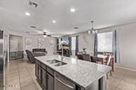 2614 S 120th Ave, Avondale, AZ 85323 - kitchen with light tile patterned floors, open floor plan, light countertops, a sink, and a ceiling fan