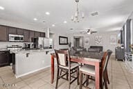2614 S 120th Ave, Avondale, AZ 85323 - dining space with light tile patterned floors, a chandelier, and recessed lighting