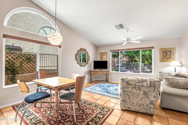 tiled dining area with ceiling fan and vaulted ceiling