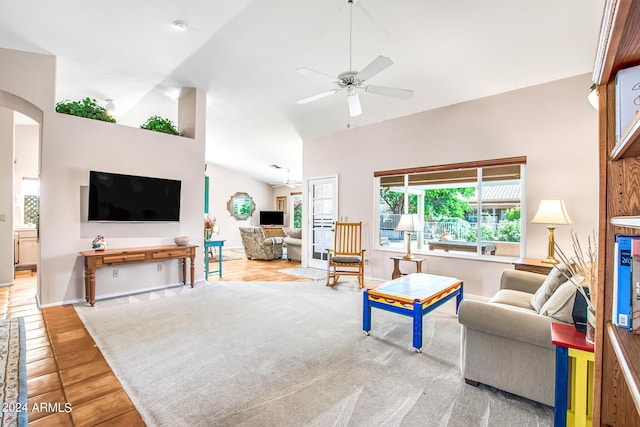 living room with ceiling fan and vaulted ceiling