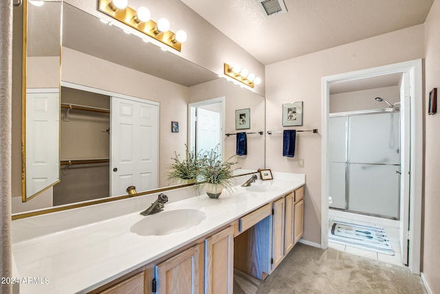 bathroom with vanity and a shower with shower door