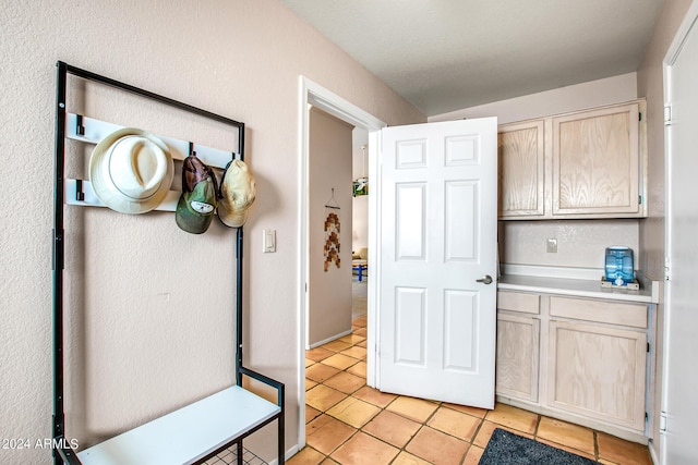 interior space featuring light brown cabinetry and light tile patterned floors