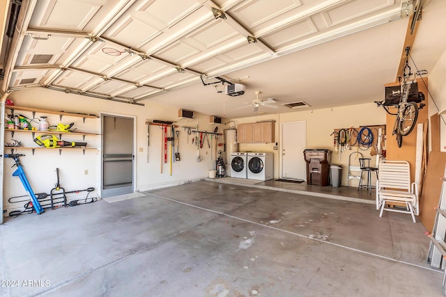 garage featuring a garage door opener, separate washer and dryer, and electric water heater