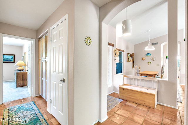 hall featuring light tile patterned floors