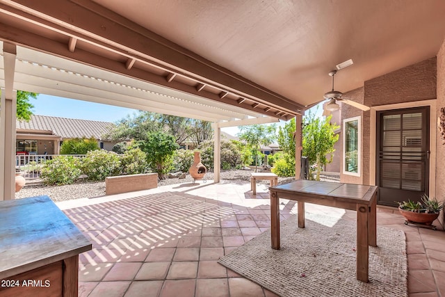 view of patio featuring ceiling fan and an outdoor fireplace