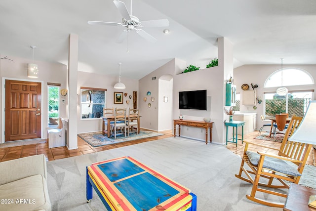 tiled living room featuring ceiling fan and lofted ceiling