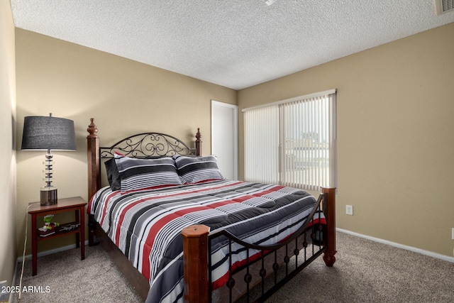 carpeted bedroom with a textured ceiling