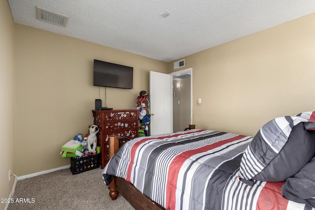 bedroom with carpet and a textured ceiling