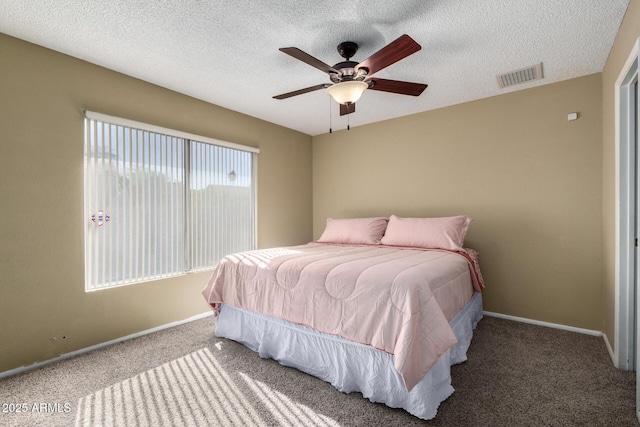 bedroom featuring carpet, a textured ceiling, and ceiling fan