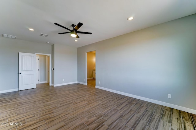 22009 W Montgomery Rd, Wittmann, AZ 85361 - spare room featuring wood finished floors, a ceiling fan, baseboards, and recessed lighting