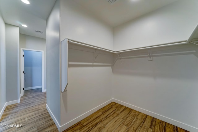 22009 W Montgomery Rd, Wittmann, AZ 85361 - walk in closet featuring light wood-style floors
