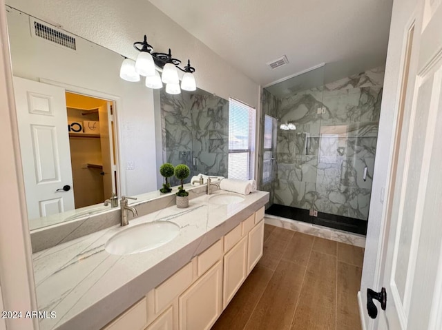 bathroom with vanity, a shower with door, and hardwood / wood-style flooring