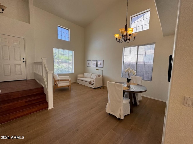 dining room with a chandelier, high vaulted ceiling, and hardwood / wood-style flooring