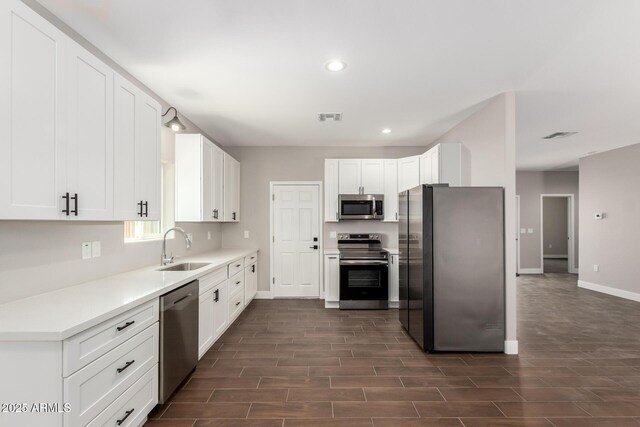 683 W Raymond St, Coolidge, AZ 85128 - kitchen featuring stainless steel appliances, a sink, baseboards, dark wood-style floors, and recessed lighting