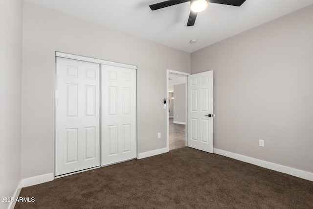 683 W Raymond St, Coolidge, AZ 85128 - unfurnished bedroom with dark carpet, a closet, baseboards, and ceiling fan