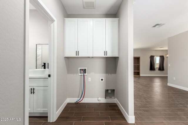 683 W Raymond St, Coolidge, AZ 85128 - washroom featuring cabinet space, wood finish floors, hookup for a washing machine, electric dryer hookup, and baseboards