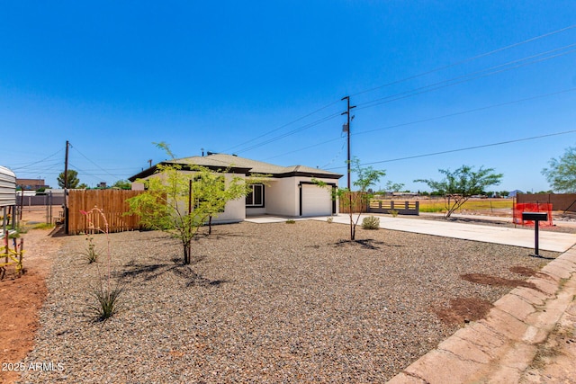683 W Raymond St, Coolidge, AZ 85128 - view of front of home featuring a garage, driveway, and stucco siding