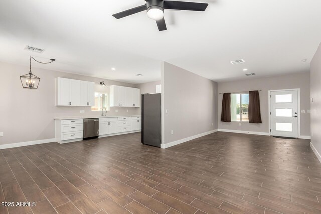 683 W Raymond St, Coolidge, AZ 85128 - unfurnished living room with baseboards, a sink, dark wood-type flooring, a ceiling fan, and recessed lighting