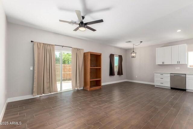 683 W Raymond St, Coolidge, AZ 85128 - unfurnished living room featuring baseboards, dark wood-style flooring, ceiling fan, and recessed lighting
