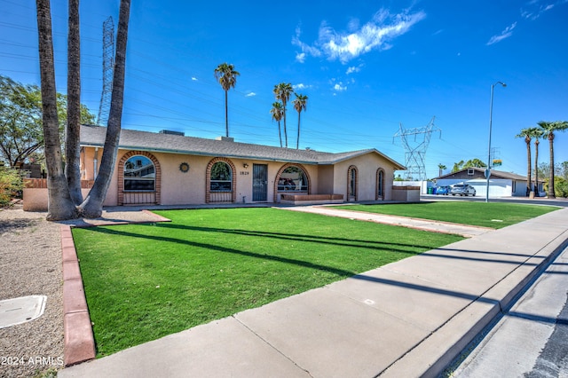 ranch-style home featuring a front yard