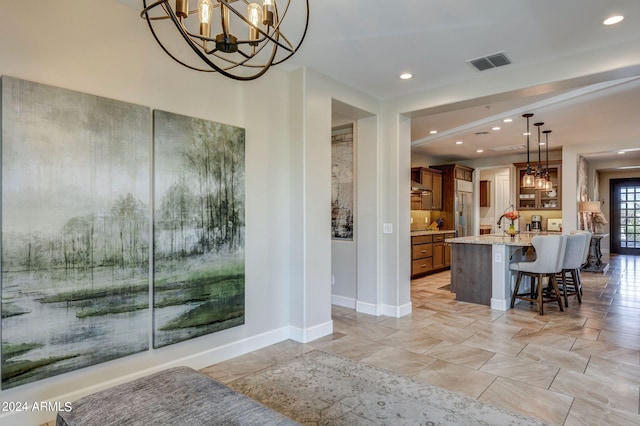 interior space with an inviting chandelier and light tile floors