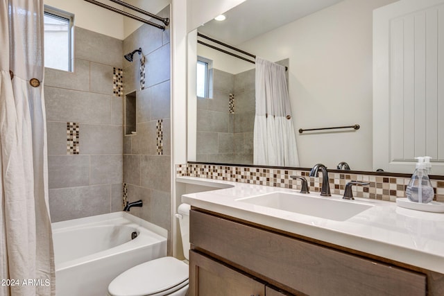 full bathroom featuring oversized vanity, shower / tub combo with curtain, backsplash, and toilet