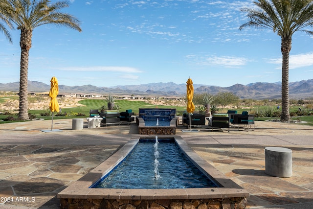 view of swimming pool featuring a patio area and a mountain view