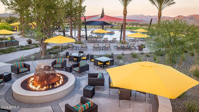 exterior space featuring an outdoor living space with a fire pit and a mountain view