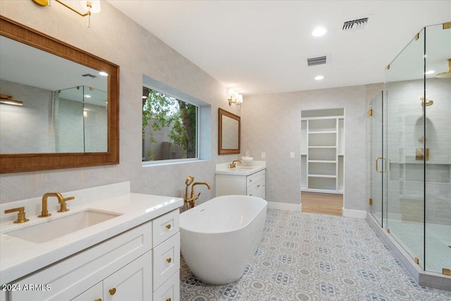 bathroom with vanity and separate shower and tub