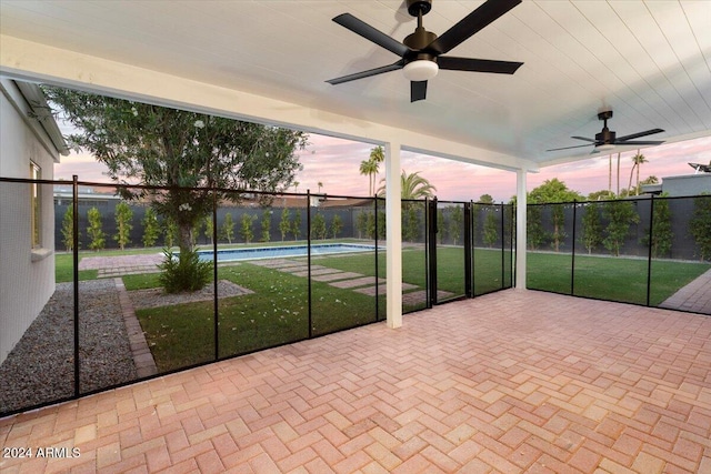 unfurnished sunroom with ceiling fan