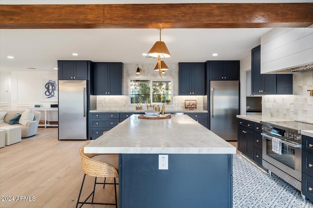 kitchen with premium appliances, light wood-type flooring, a kitchen island, beamed ceiling, and pendant lighting