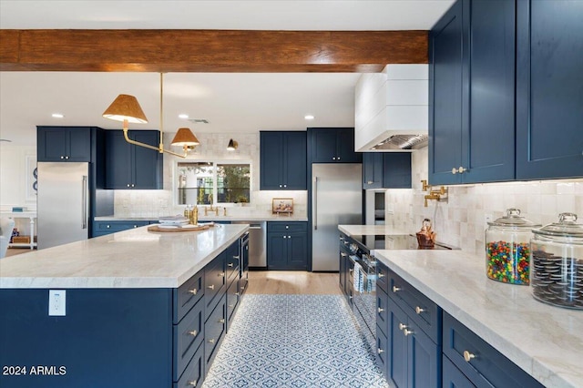 kitchen featuring tasteful backsplash, blue cabinets, custom exhaust hood, appliances with stainless steel finishes, and beam ceiling