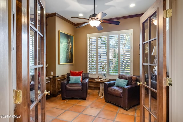 living area featuring crown molding, french doors, ceiling fan, and a healthy amount of sunlight