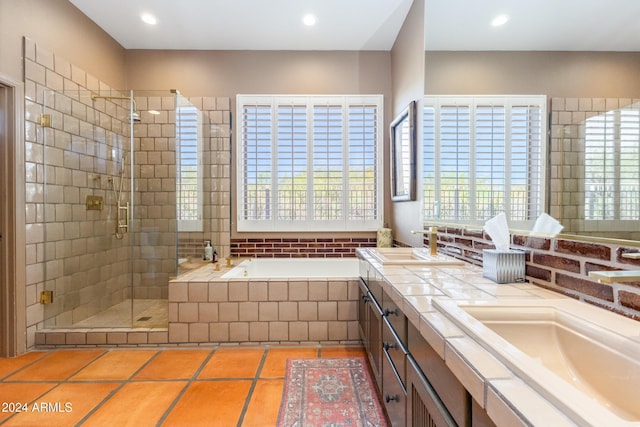 bathroom featuring tile patterned flooring, vanity, separate shower and tub, and a healthy amount of sunlight