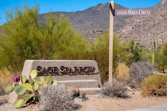 community sign with a mountain view