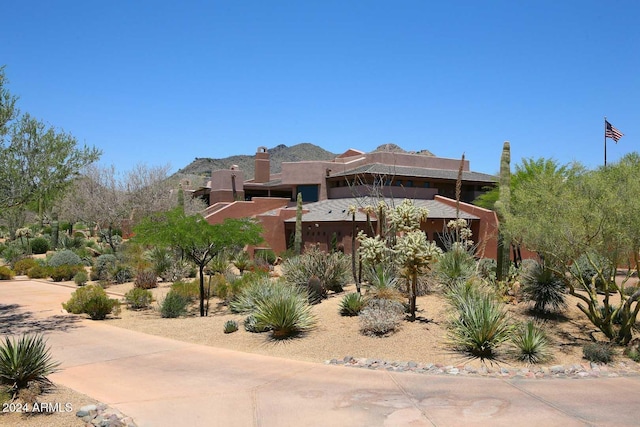 pueblo revival-style home with a mountain view