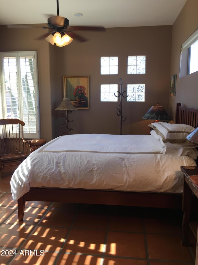 bedroom featuring ceiling fan and dark tile patterned floors