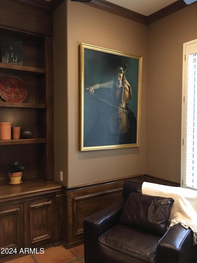 living area featuring a healthy amount of sunlight, light tile patterned floors, and crown molding