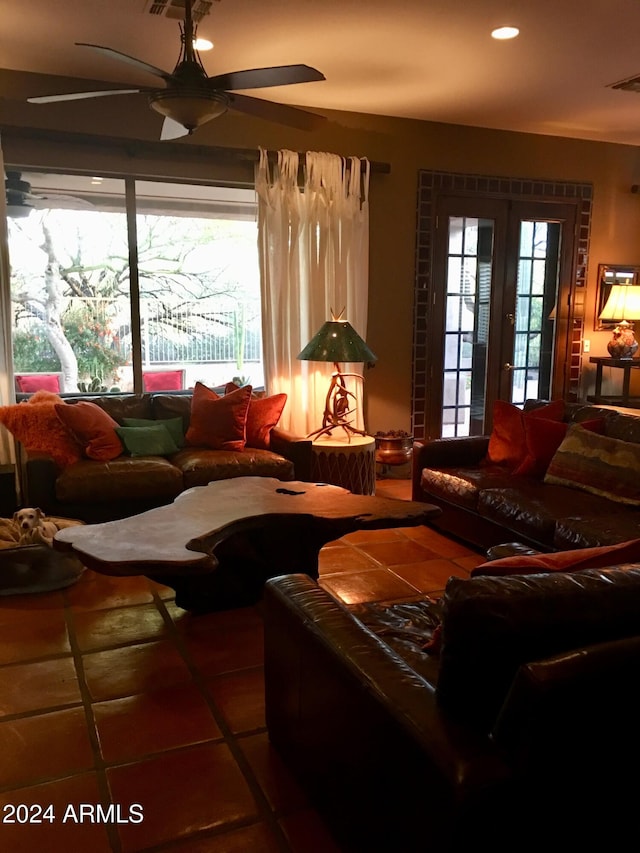 tiled living room with a wealth of natural light and ceiling fan