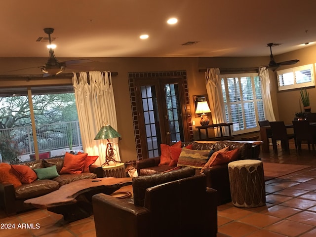 living room featuring ceiling fan, plenty of natural light, and light tile patterned floors