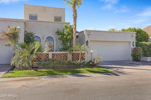 pueblo-style house with a garage