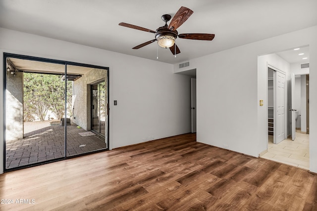 empty room featuring hardwood / wood-style floors and ceiling fan