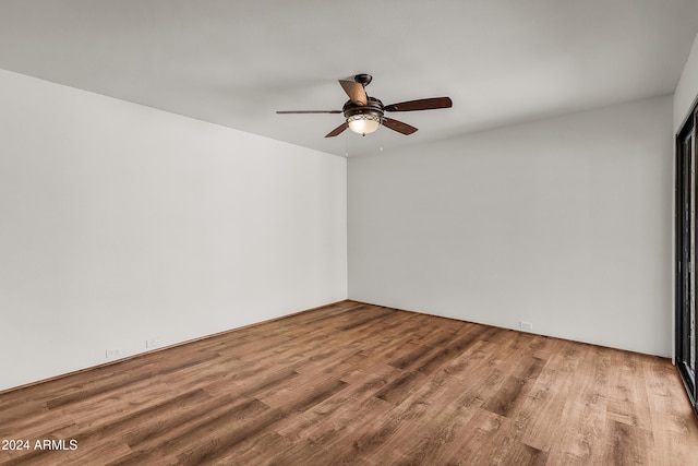 unfurnished room with hardwood / wood-style flooring