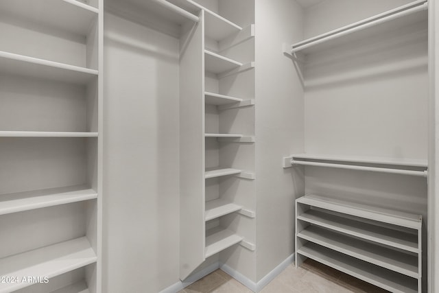 spacious closet featuring light tile patterned floors