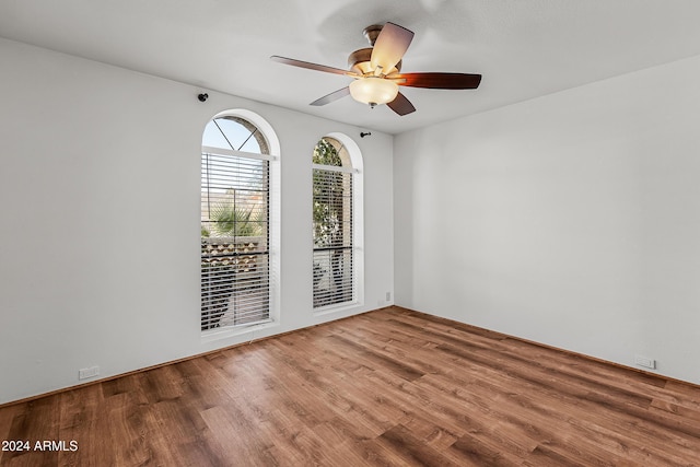 empty room featuring ceiling fan and wood-type flooring