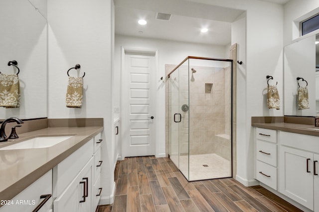 bathroom featuring vanity and a shower with shower door